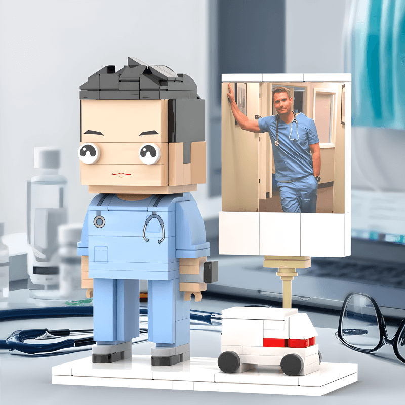 Lego figure of a doctor with a small model ambulance on a desk.