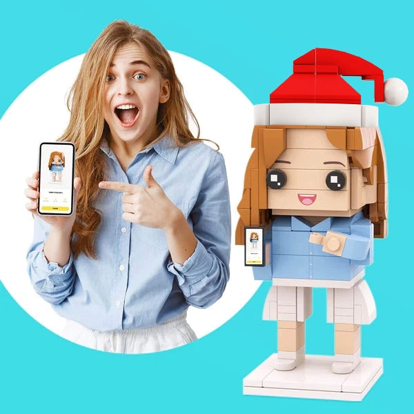 Person pointing at a smartphone with a LEGO-style figure of a person wearing a Santa hat on a blue background.
