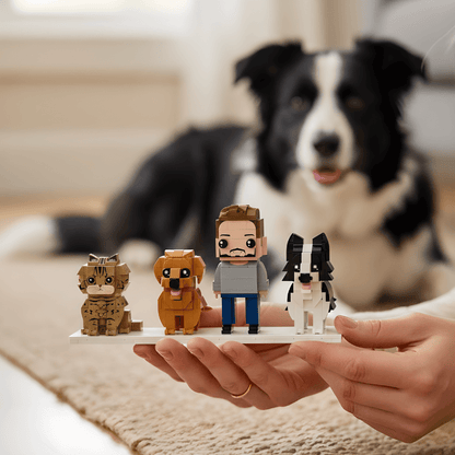 Person holding a small figurine of a man with a dog, with a real dog in the background.