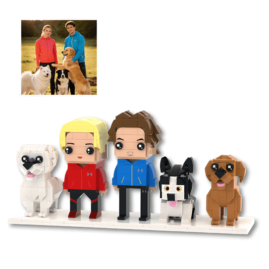 Set of small custom figurines resembling people and dogs on a white surface with a photo of two people and two dogs in the corner.
