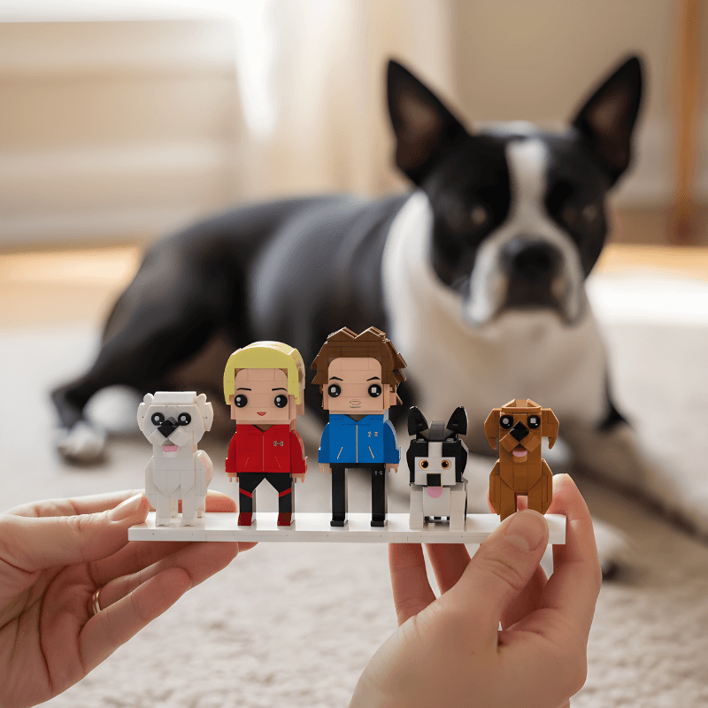 Person holding a small lego figurine display with cartoon-style characters in front of a dog.