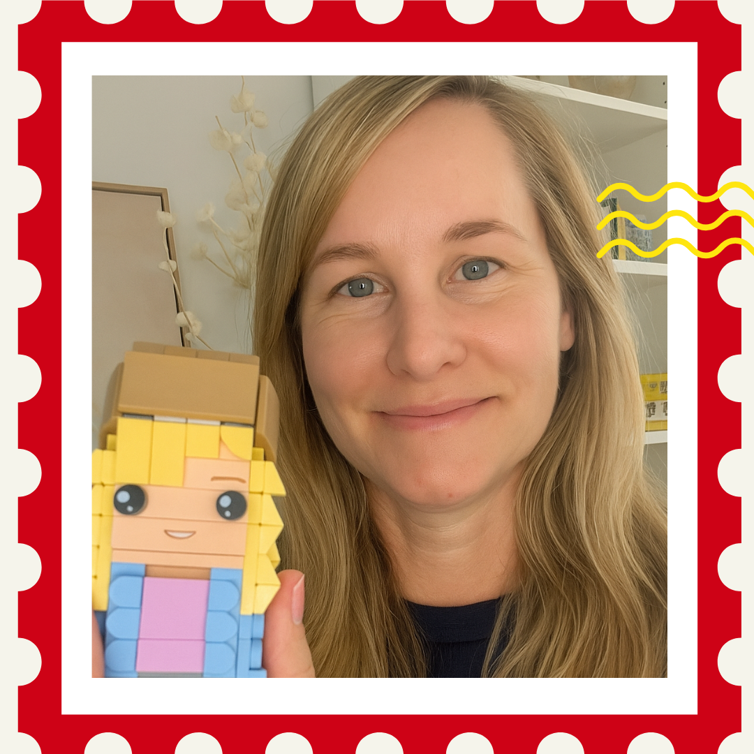 Person holding a toy figure with a red border and decorative elements
