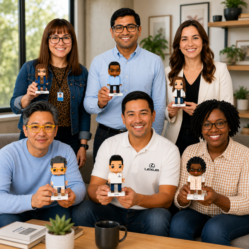 Group of people holding personalized brick figures in a casual office setting for corporate orders