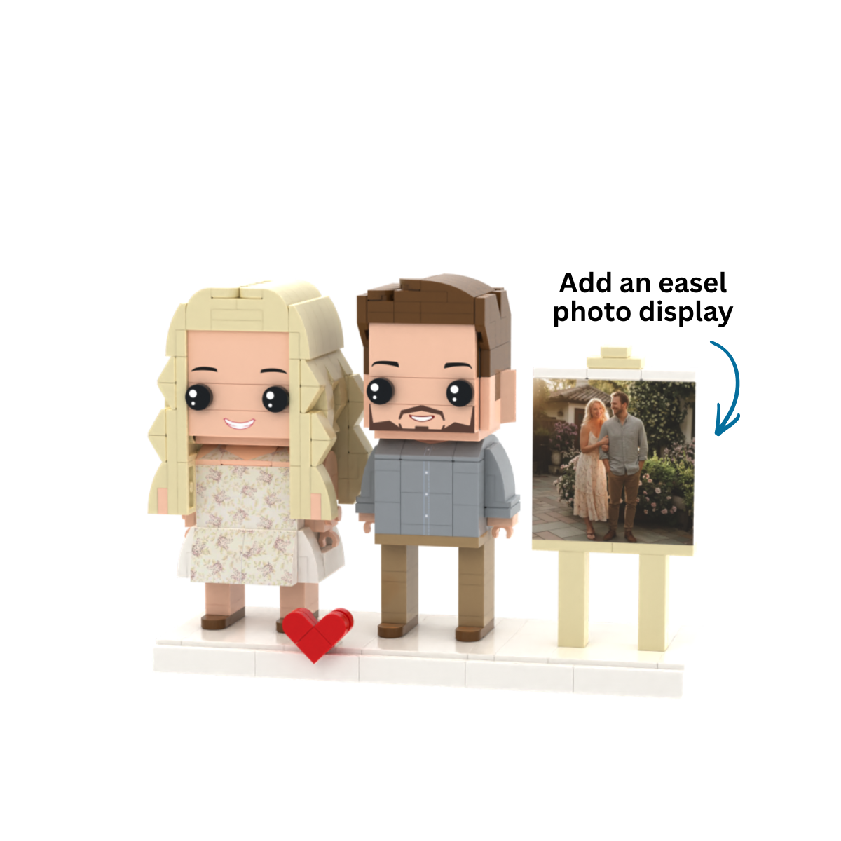 Custom block figure couple set with a blonde woman in a floral dress, a brown-haired man in a blue shirt, a red heart, and a small easel displaying a photo of the couple, on a white background.
