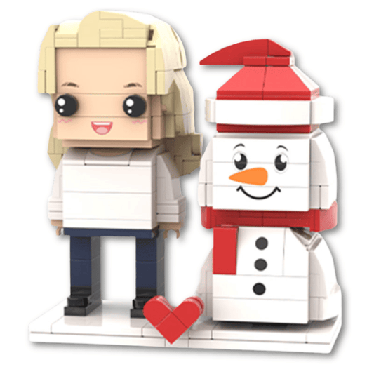 Two custom mini figures, one resembling a person with blonde hair and the other a snowman with a red hat and scarf, accompanied by a red heart.