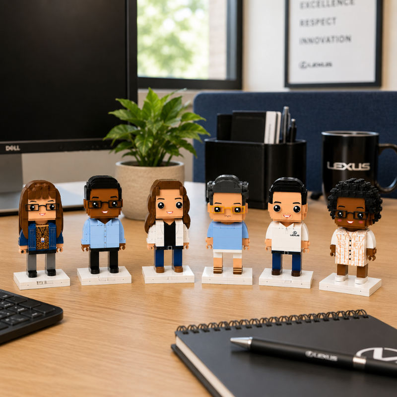 Set of six custom brick figurines on a desk with office items in the background
