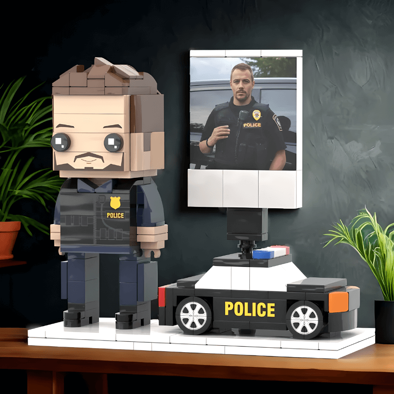 Lego custom figure of a police officer with a small model car and a photo frame on a dark background.