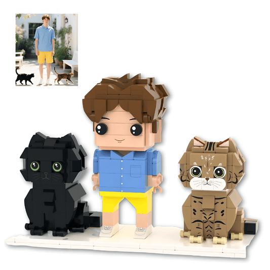 Personalised mini figure of a boy with two cats made from interlocking bricks on a white background.