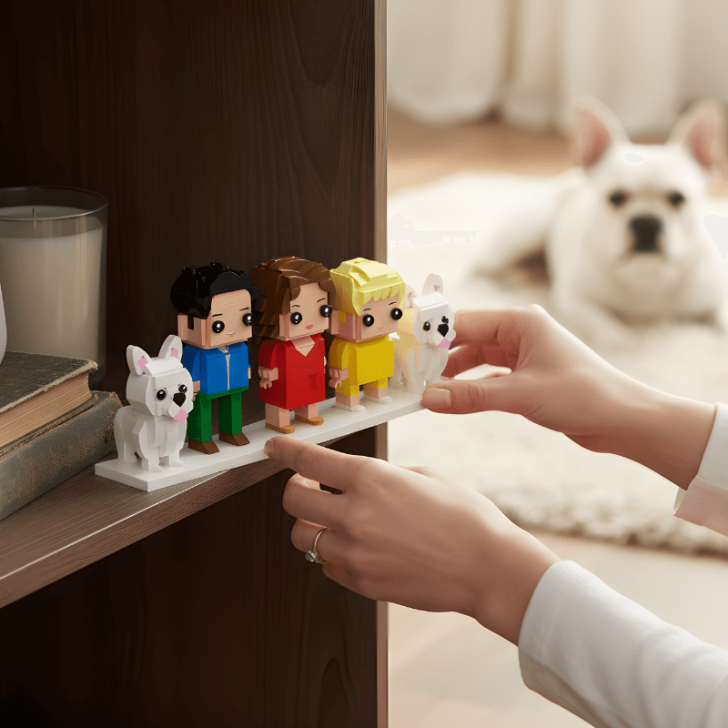 Person arranging custom mini family figurines on a shelf with a dog in the background