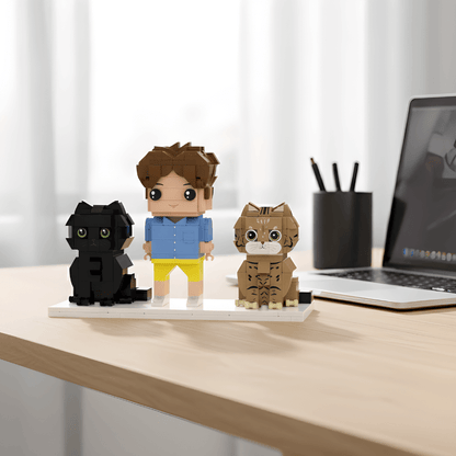 Custom mini figurines cat and owner on a desk with a laptop in the background