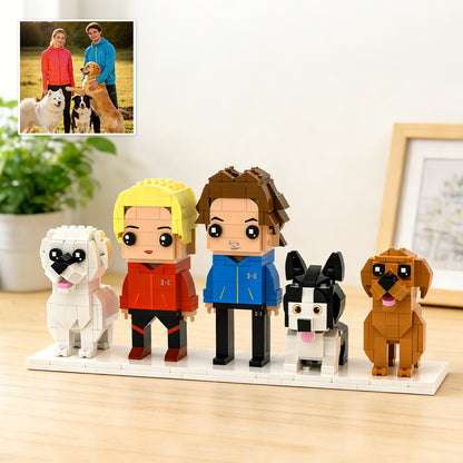 Brick-built figures of people and dogs on a display stand with a photo of real people and dogs in the corner.