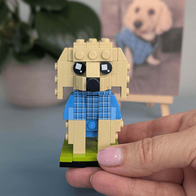Hand holding a small LEGO dog figure custom dog gift for owner