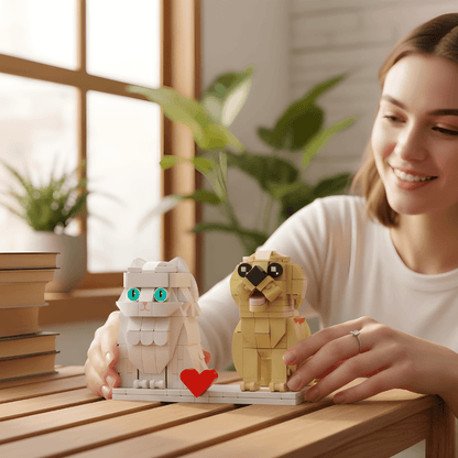 Woman holding two LEGO cat and dog models on a wooden table with a blurred indoor background
