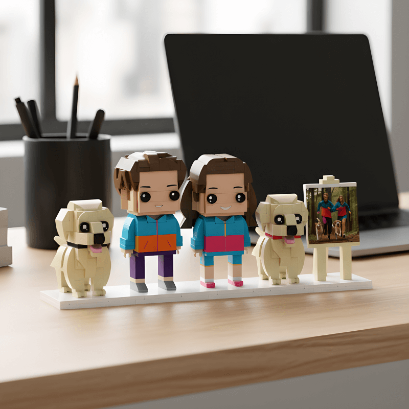Set of lego-like figures and dogs on a desk with a laptop in the background