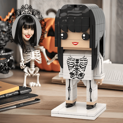 Custom Halloween figure made of interlocking bricks with a skeleton design on a wooden surface.