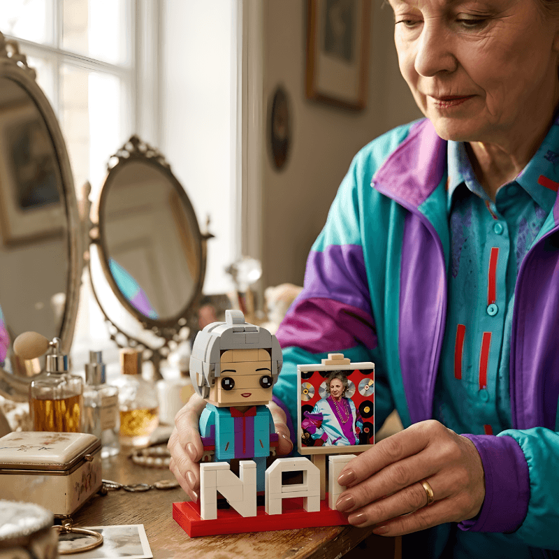 Person holding a figurine with 'Nana' and a photo of a woman, in a room with mirrors and decor.