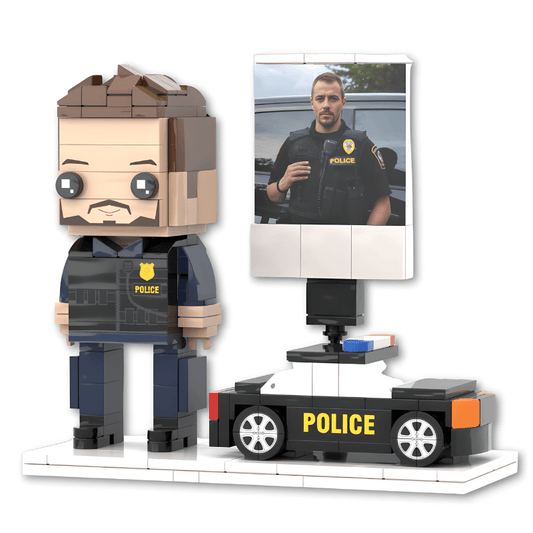 Custom mini figure of a police officer with a small model car and a photo of a real police officer on a screen.
