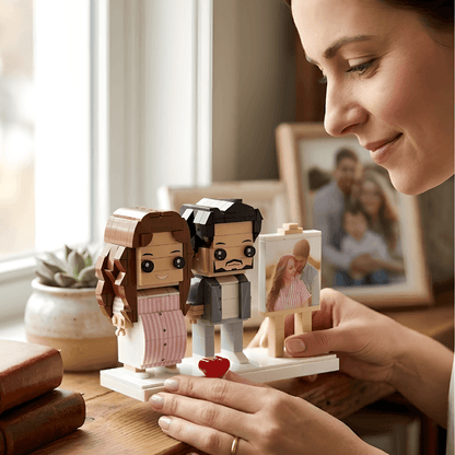 Person holding a custom LEGO-like figure set with a small photo frame, in a home setting.