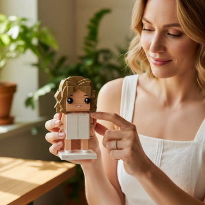Woman holding a custom mini figurine with a neutral background