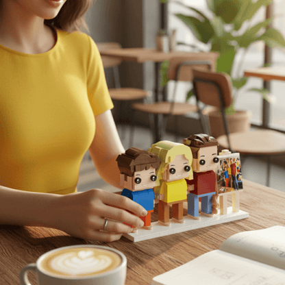 lady arranging a set of three custom mini figures with a small easel frame